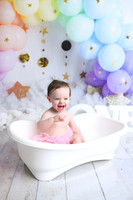 Rainbow balloons, white bathtub